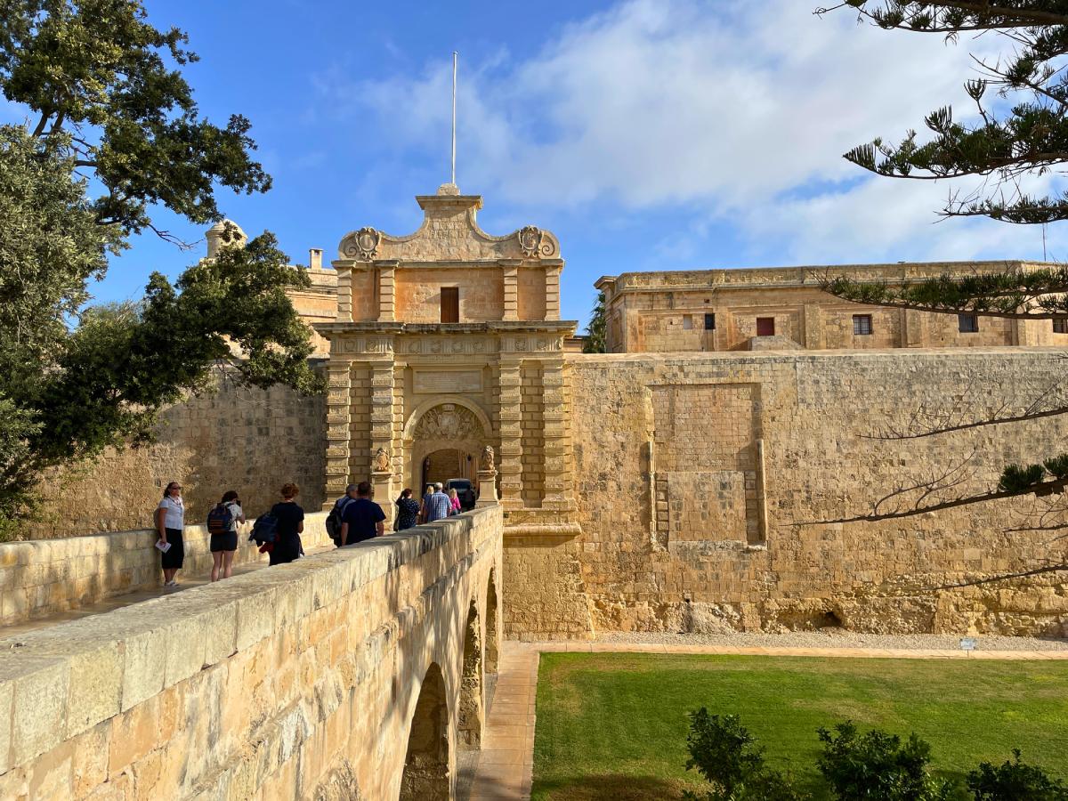 Mdina Gate with few tourists and nicely green grass