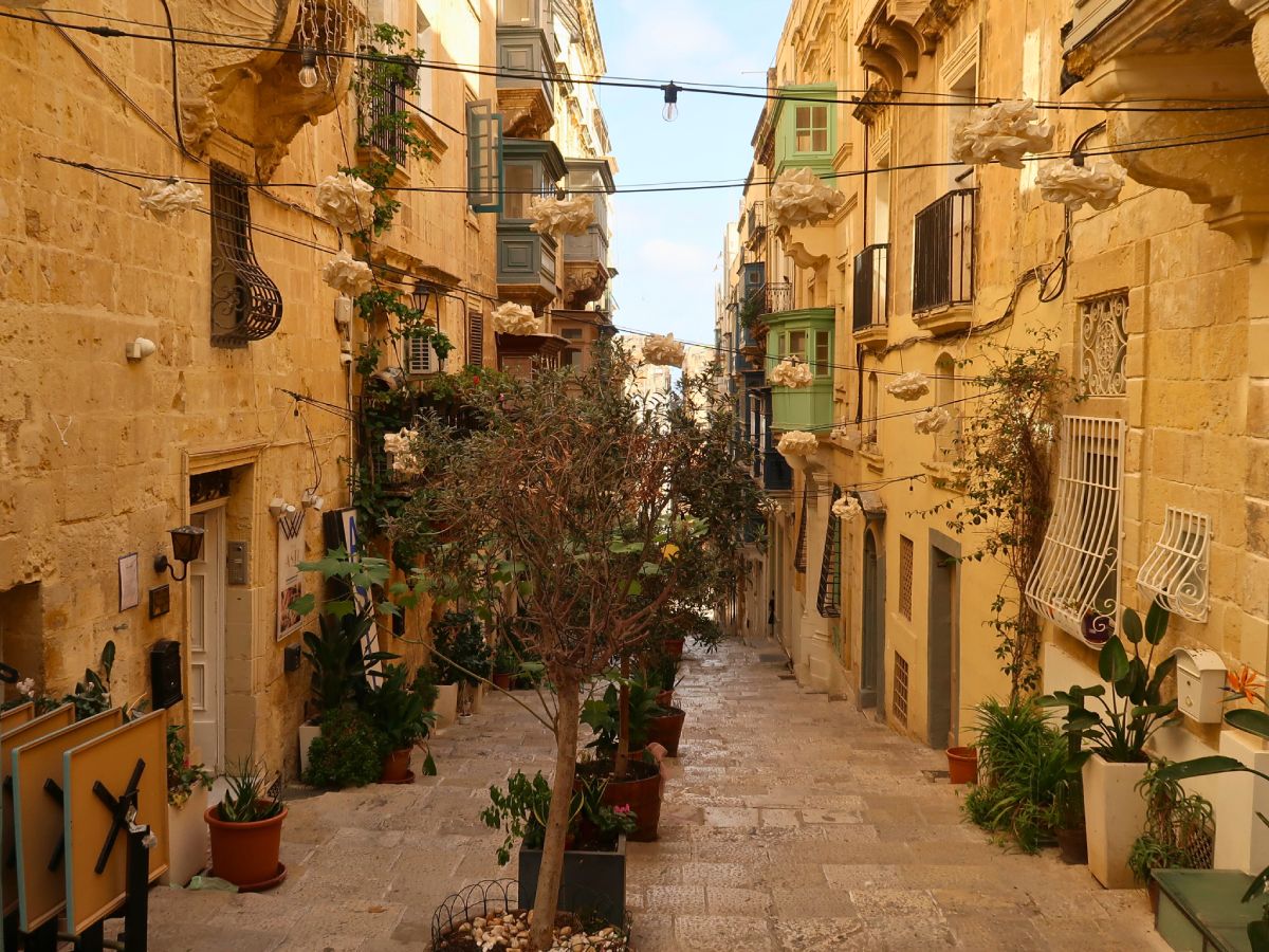 beautiful yellowish st.ursula street with colorful balconies in valletta